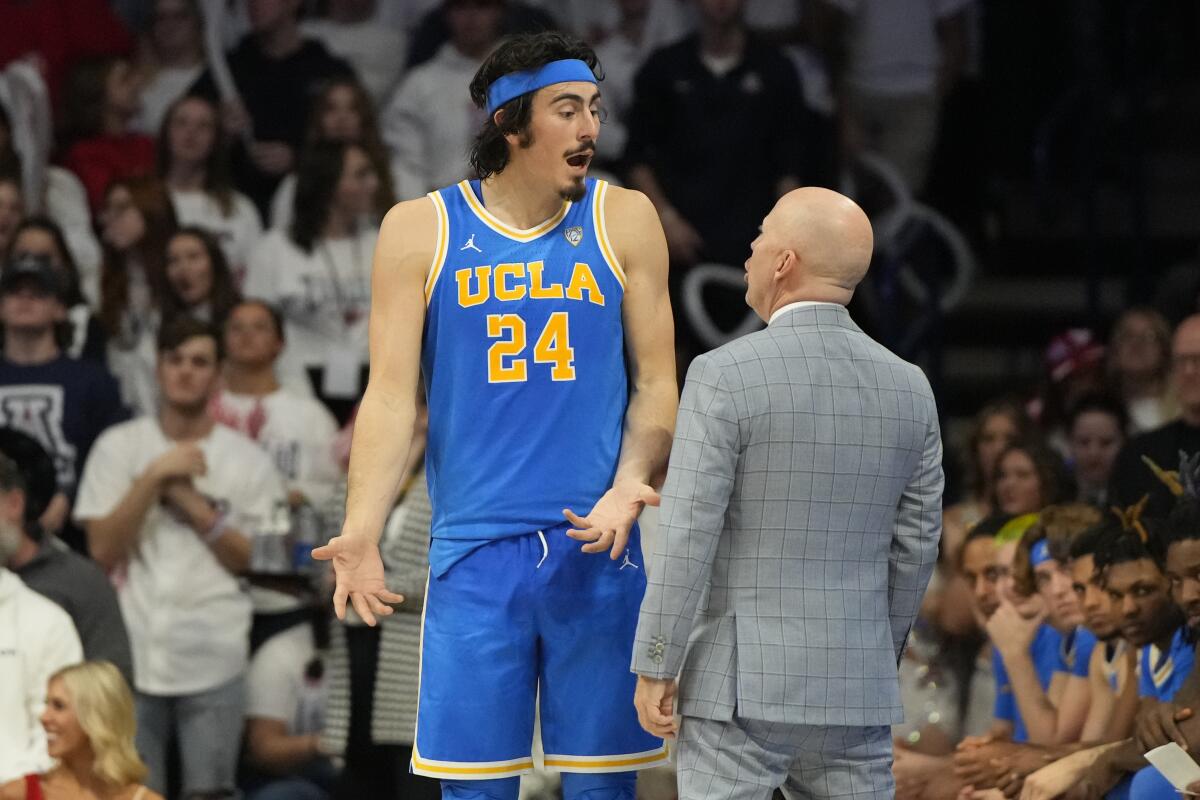 UCLA guard Jaime Jaquez Jr. talks to head coach Mick Cronin.