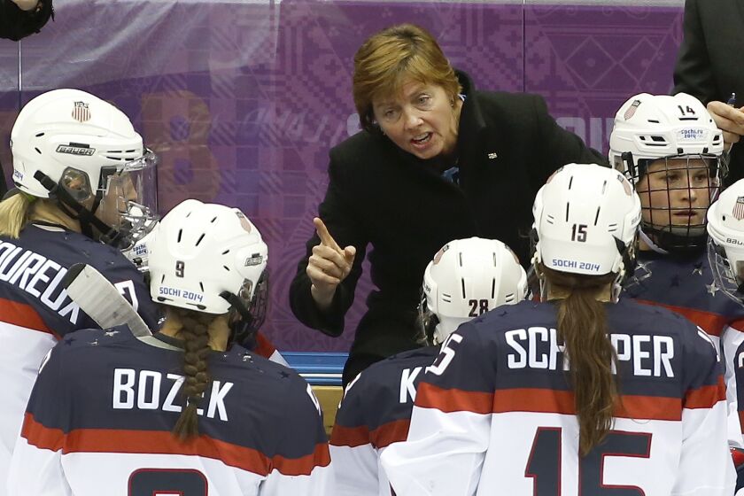 FILE - USA head coach Katey Stone talks to the team during a break in the action against Canada in the second period of the women's gold medal ice hockey game at the 2014 Winter Olympics, Thursday, Feb. 20, 2014, in Sochi, Russia. One of the most decorated coaches in women’s hockey history has stepped down after nearly 30 years leading Harvard’s women’s hockey program in the shadow of allegations by players that she engaged in abuses and other misconduct during her tenure. The school said Tuesday, June 6, 2023, that Katey Stone had made the decision to retire from coaching. (AP Photo/Petr David Josek, File)