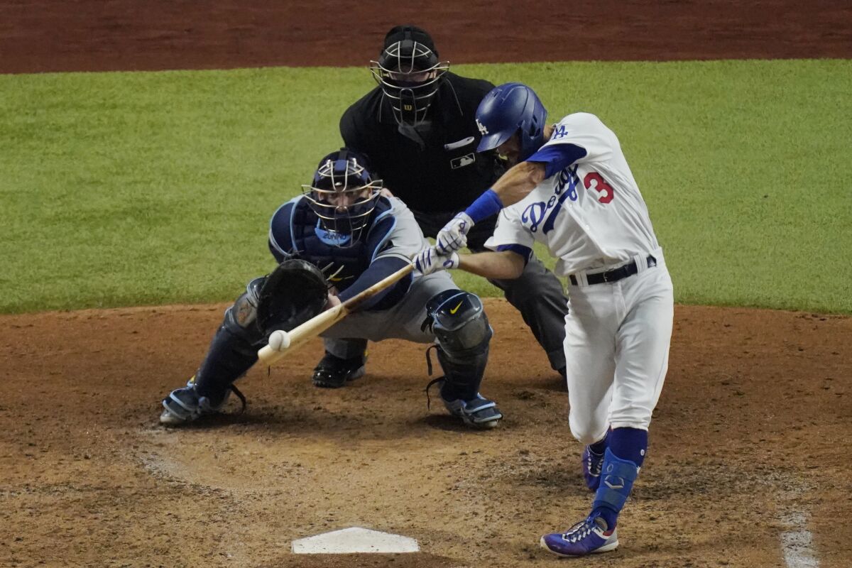 Dodgers left fielder Chris Taylor hits a two-run home run against the Tampa Bay Rays during the fifth inning of Game 2.