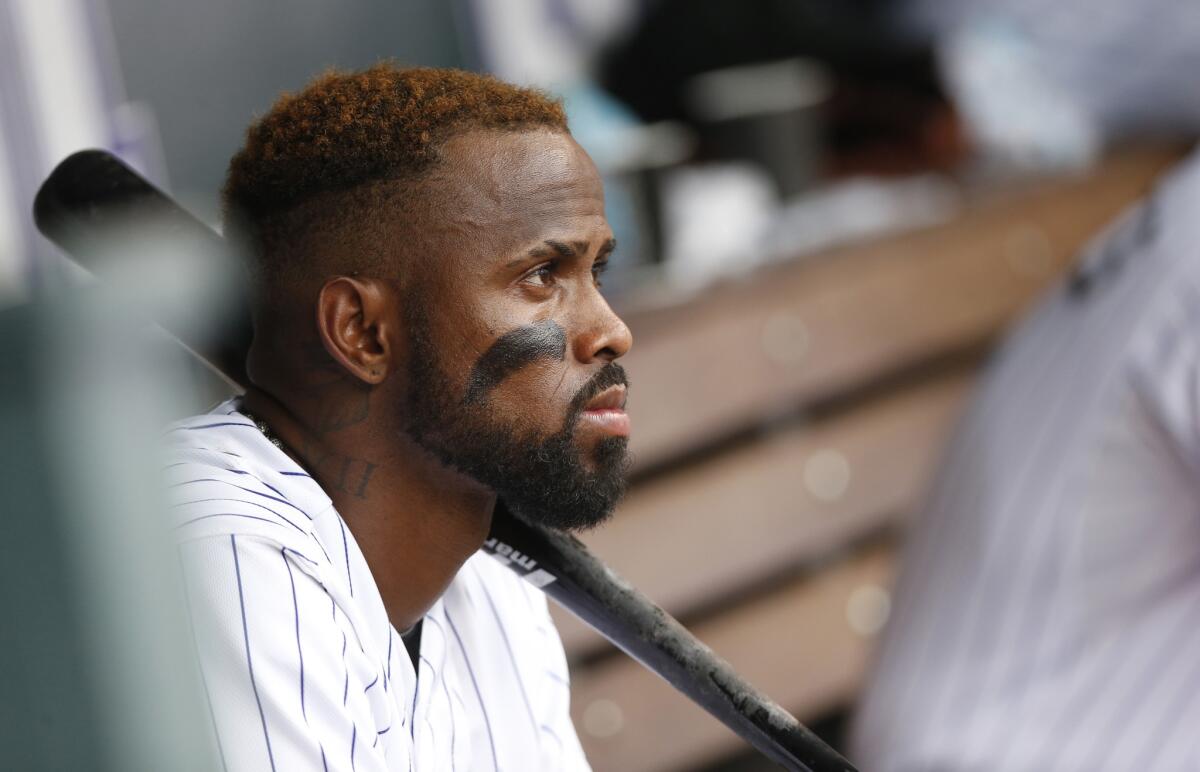Colorado Rockies shortstop Jose Reyes watches from dugout on Aug. 16.