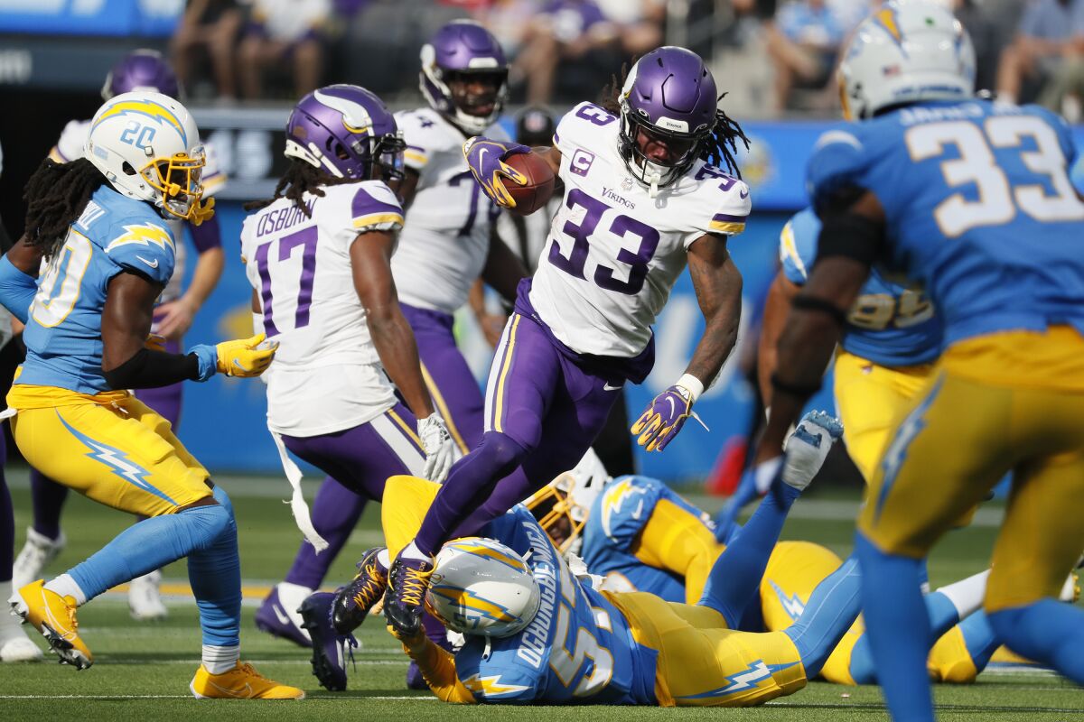 Minnesota Vikings running back Dalvin Cook carries the ball for a short gain in a 27-20 victory over the Chargers.