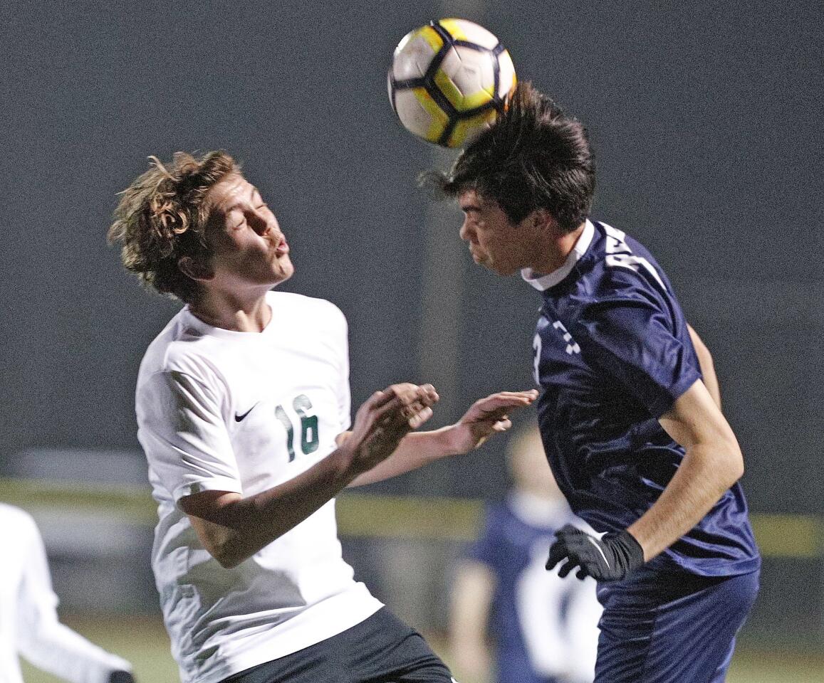 Flintridge Prep's Eric Ahn heads the ball before Providence's Arthur Martinyan can get to him in a Prep League boys' soccer game at the Glendale Sports Complex on Thursday, January 17, 2019.