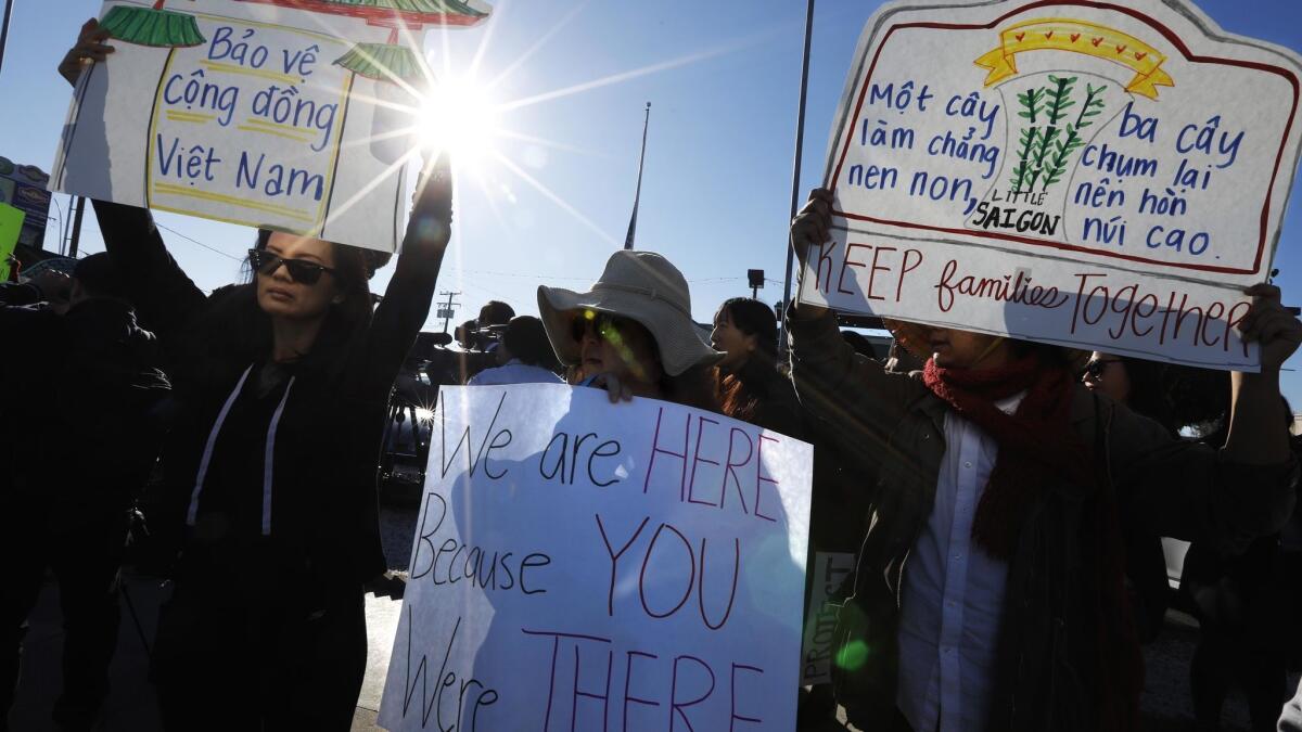 Thuy Vo Dang, 39, left, Tram Le, 45, center, and Fusako Takeda, 74, join members of the Little Saigon community at a protest after the Trump administration said thousands of Vietnam War refugees who later committed crimes in the U.S. should not be protected from deportation.