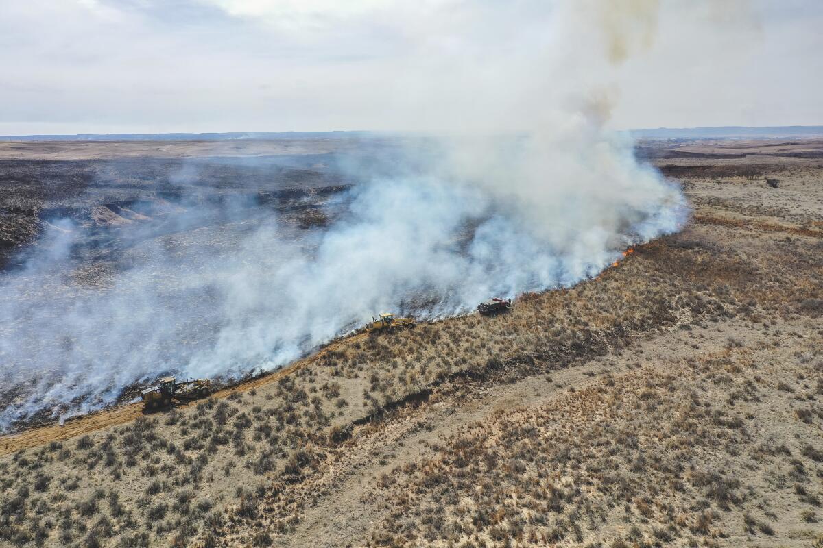 Firefighters battle the Smokehouse Creek Fire north of Canadian, Texas.