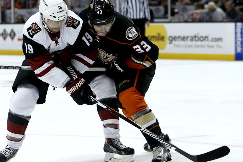 Ducks right wing Jakob Silfverberg (33) battles Coyotes right wing Shane Doan (19) for possession of the puck in the first period Wednesday night in Anaheim.