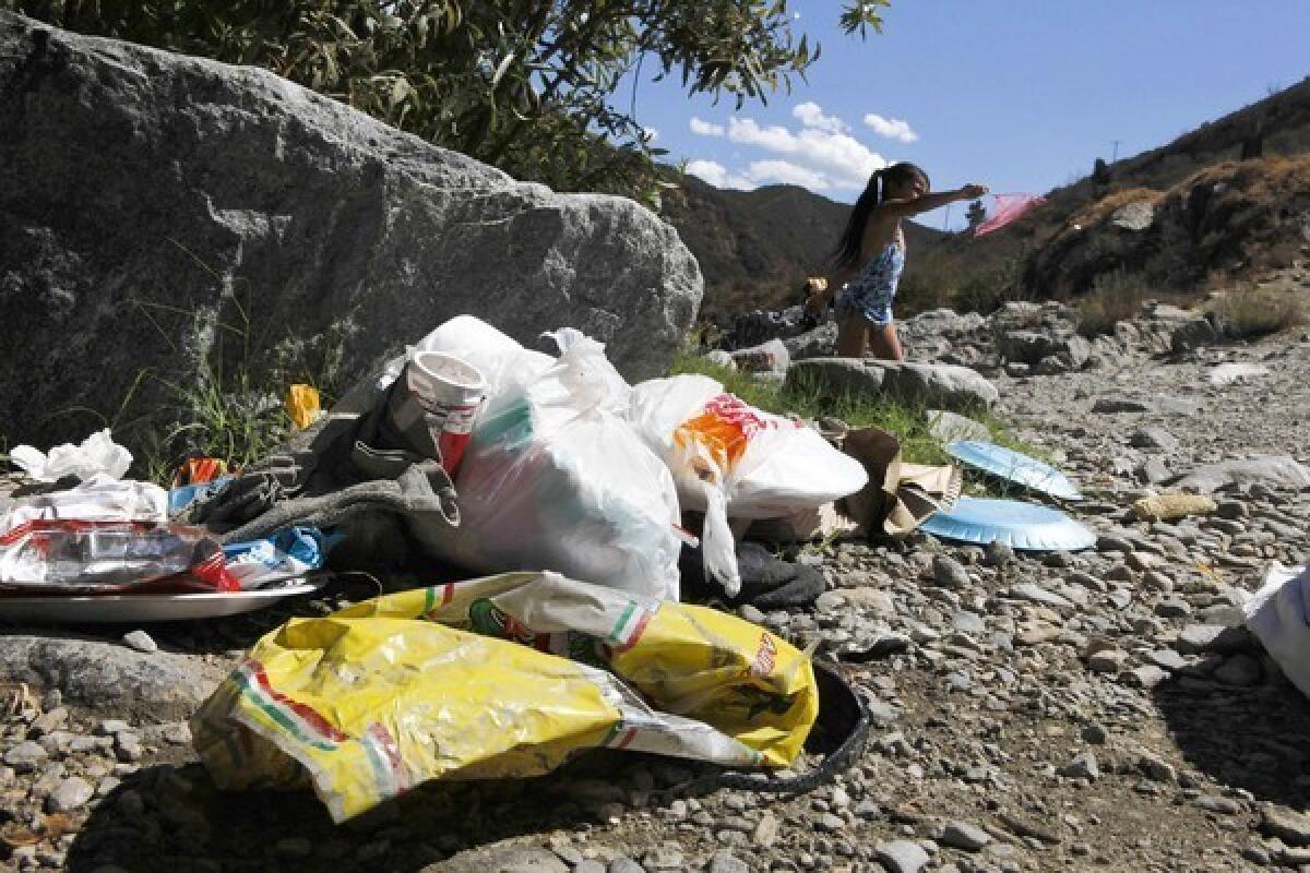 Trash fouls the banks of the East Fork of the San Gabriel River in the Angeles National Forest.