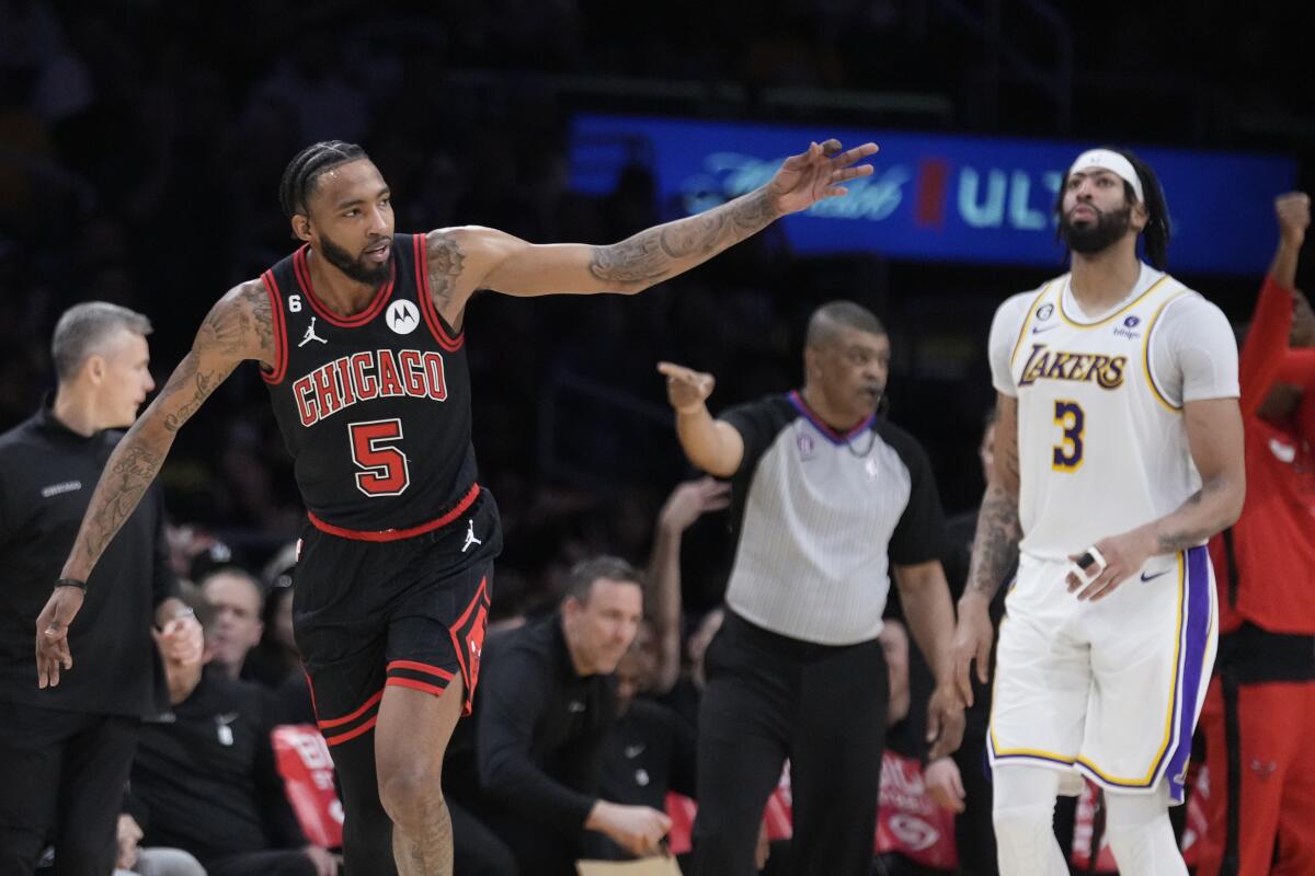 Chicago Bulls forward Derrick Jones Jr. reacts after making a three-point basket in front of Lakers forward Anthony Davis.