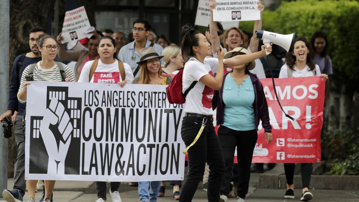 Members of a coalition of legal advocates, community organizations and tenants fighting for rent stabilization and fair housing practices marched to the Board of Supervisors meeting ahead of a vote Tuesday on a measure to cap rent increases in unincorporated areas of L.A. County.