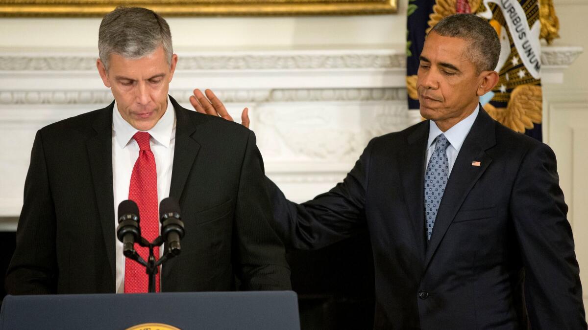 President Obama pats Education Secretary Arne Duncan's back in the White House on Oct. 2, 2015, as Duncan announces that he will be stepping down after 7 years in the Obama administration.