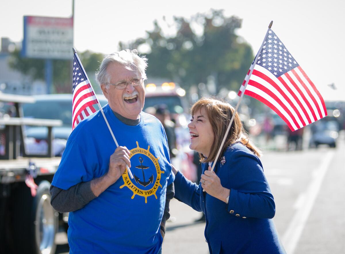 Rep. Loretta Sanchez (D-Orange) laughs with Bob Jones of the Fresno County Democratic Committee at the Veterans Day Parade in Fresno in 2015.