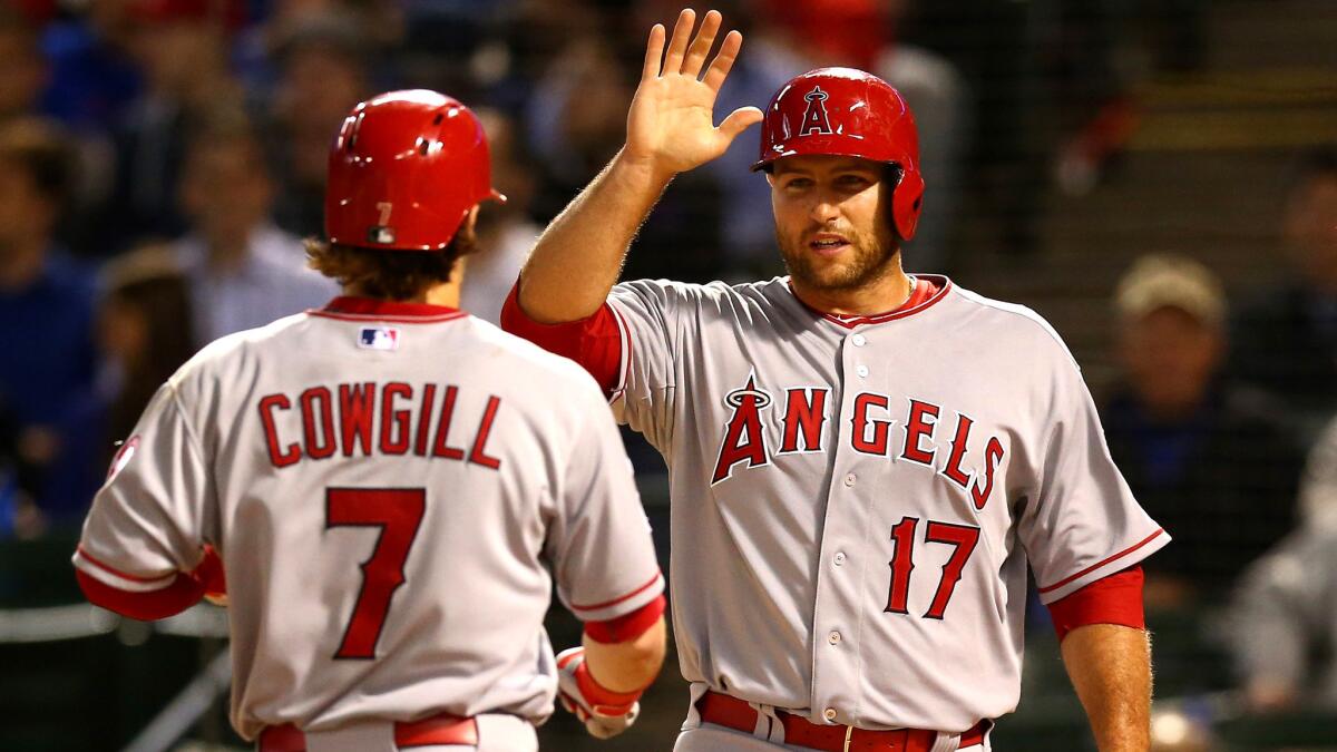 Angels catcher Chris Iannetta (17) congratulates teammate Collin Cowgill after he hit a home run against the Rangers on April 13.