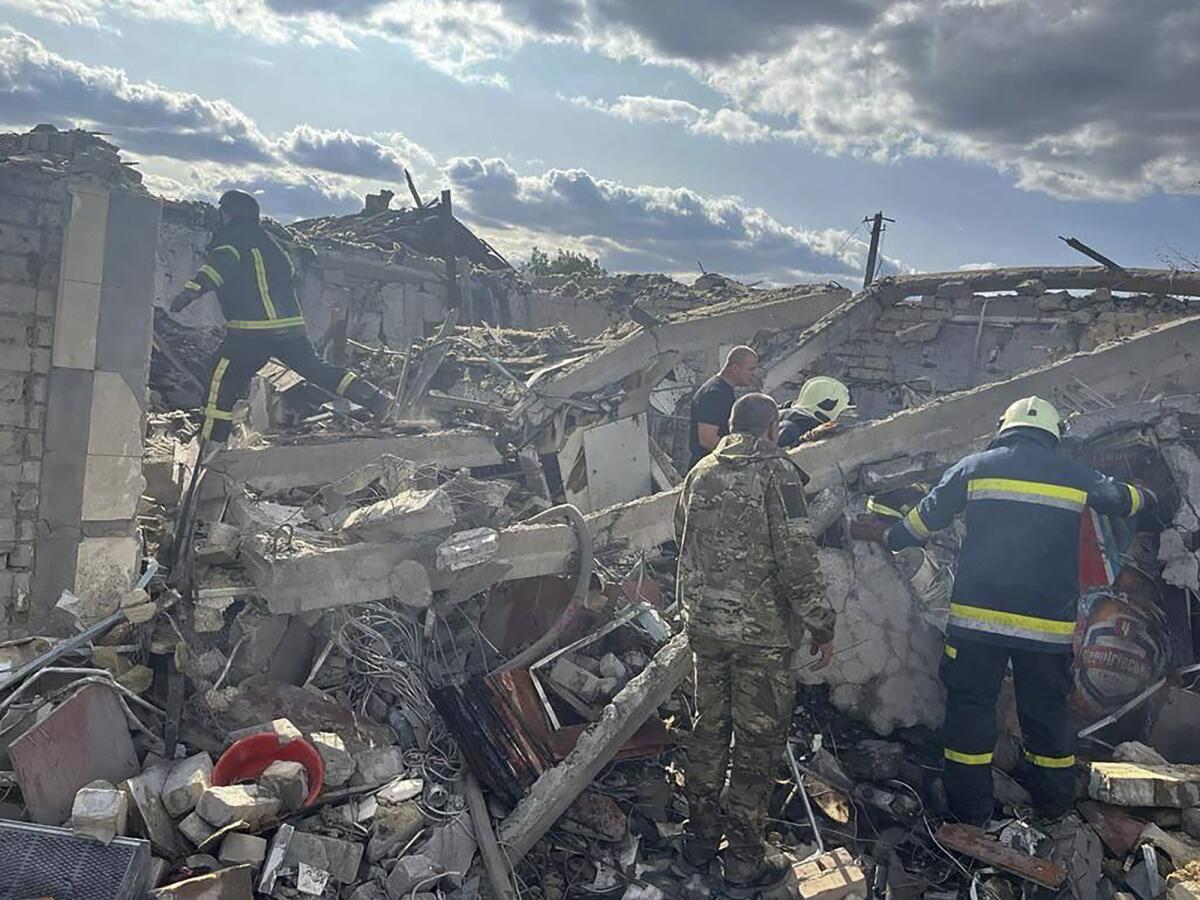 Emergency workers searching for victims in rubble from a Russian rocket attack