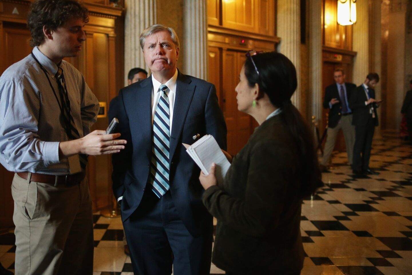 Sen. Lindsey Graham (R-S.C.) talks with reporters before attending the weekly Senate Republican Caucus policy luncheon at the Capitol.