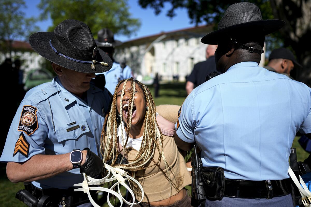Georgia State Patrol officers detain a demonstrator on the campus of Emory University during a pro-Palestinian demonstration.