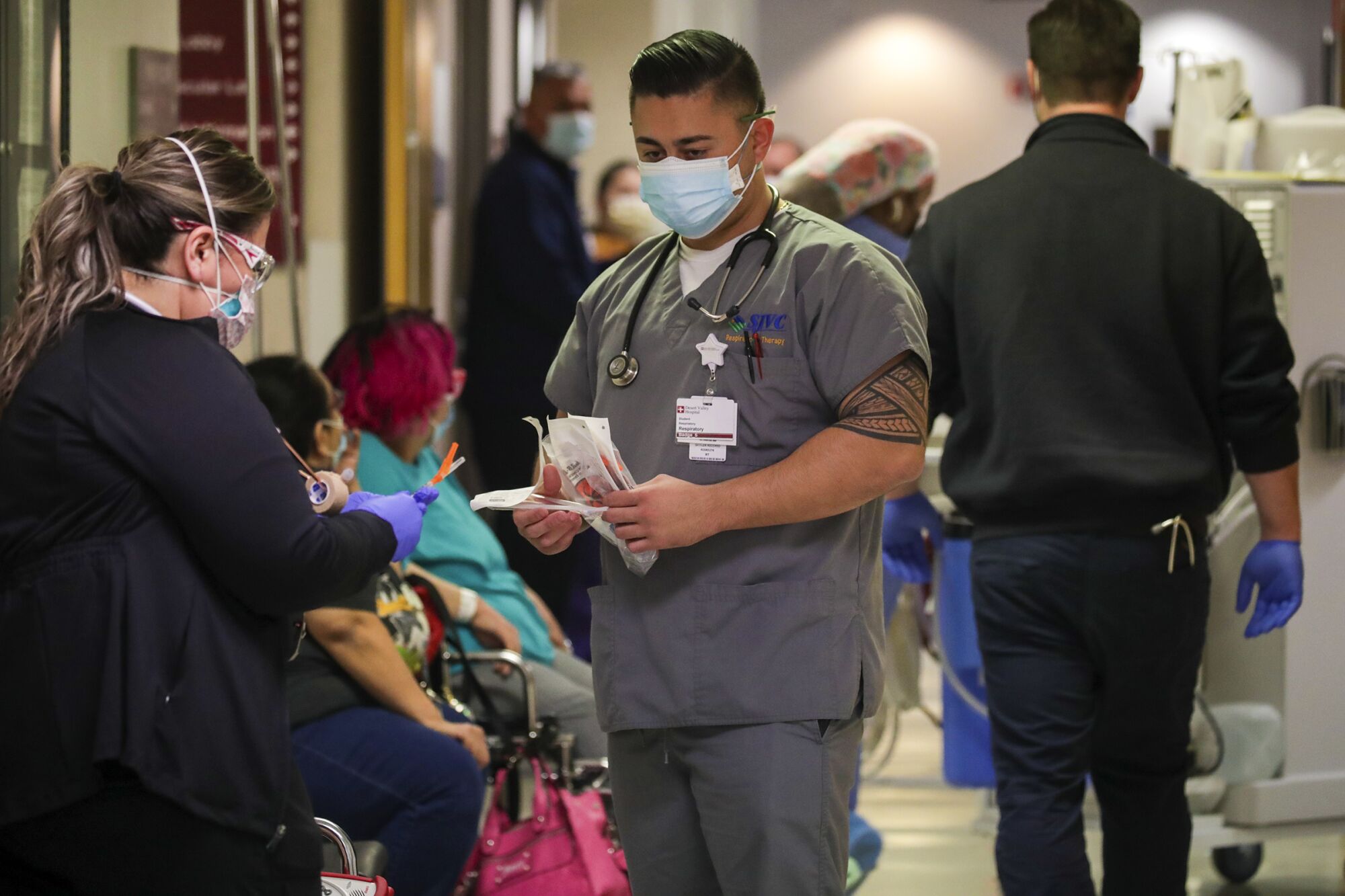 Two medical workers in a hospital hallway