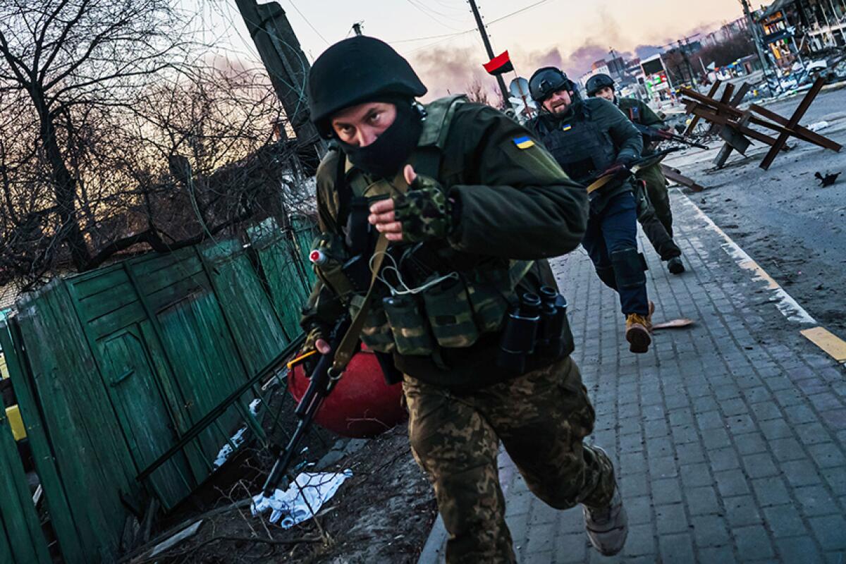 Ukrainian soldiers return from fighting Russian forces in Irpin, just outside Kyiv, in March.