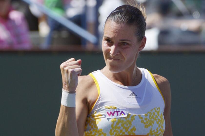 Flavia Pennetta reacts after winning the first set of her victory over Agnieszka Radwanska in the BNP Paribas Open final at Indian Wells on Sunday.