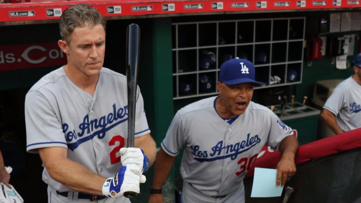 Dodgers second baseman Chase Utley and Manager Dave Roberts stand in the dugout during a game against the Reds on Aug. 19.