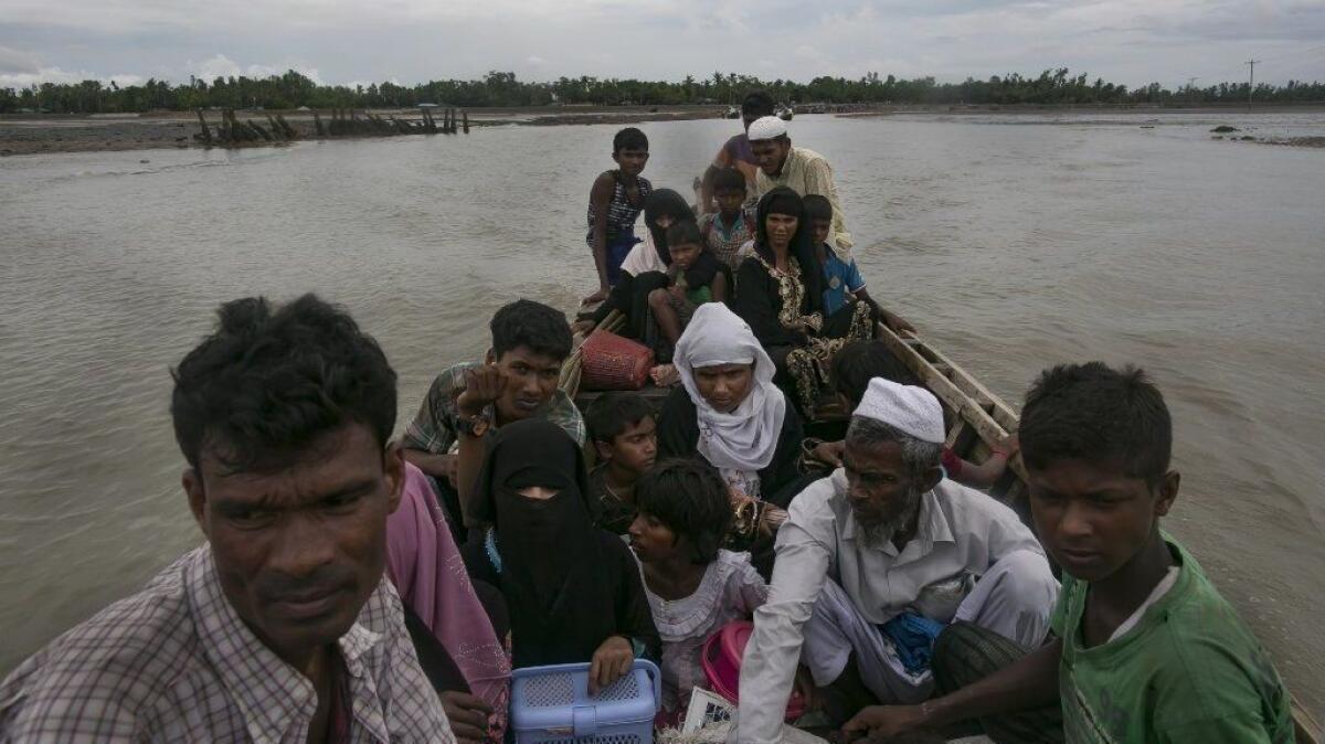 Rohingya refugees cross into mainland Bangladesh on Sunday after fleeing Myanmar.