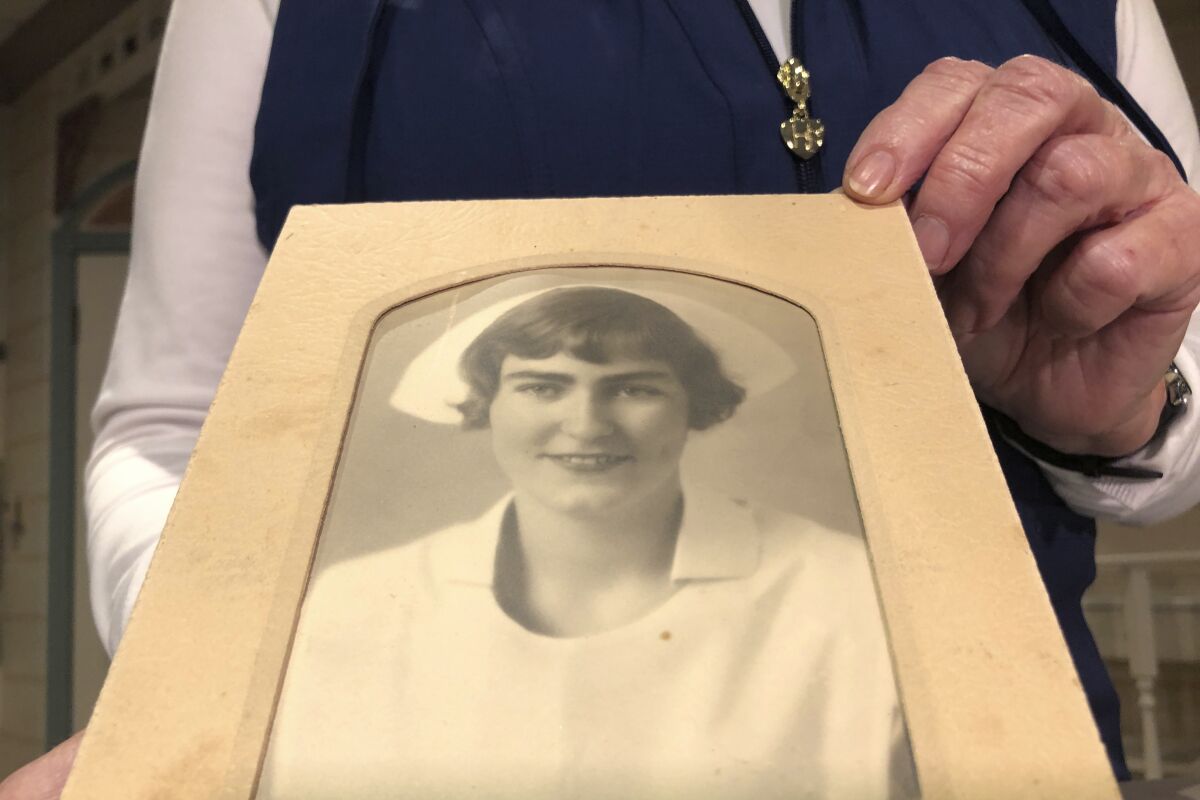 Sigrid Stokes holds a photo of her mother