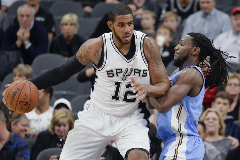 San Antonio's LaMarcus Aldridge, left, drives around Denver's Kenneth Faried on Nov. 18.