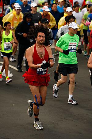 A male runner, clad in a red dress