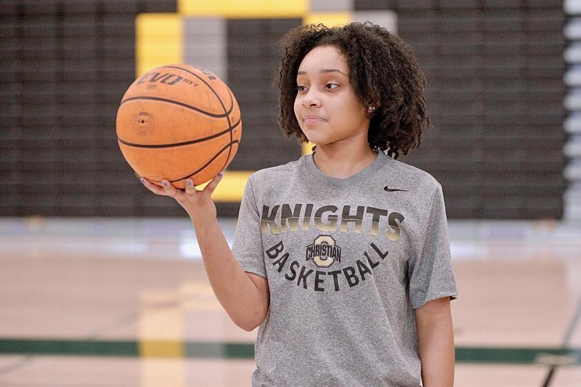 Ontario Christian freshman basketball star Kaleena Smith poses for a photo holding a basketball in her right hand.