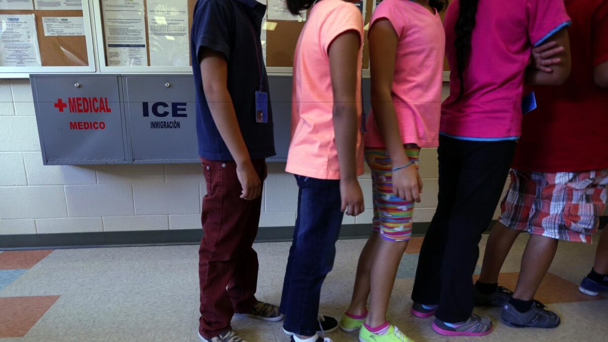 Detained immigrant children line up inside the Karnes County Residential Center, a temporary home for immigrant women and children detained at the border, in Karnes City, Texas in 2014.
