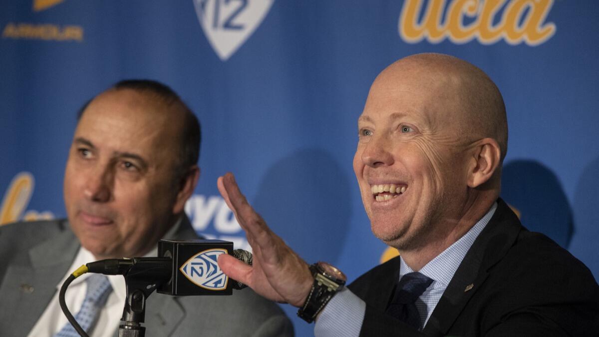 New UCLA basketball coach Mick Cronin, right, sits next to athletic director Dan Guerrero during an introductory news conference Wednesday in Westwood.