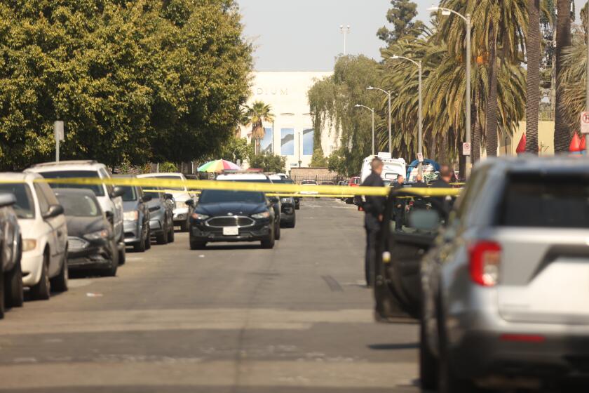 South Los Angeles, CA - June 01: Yellow tape from a double homicide shooting in Exposition Park on Saturday, June 1, 2024 in South Los Angeles, CA. (Michael Blackshire / Los Angeles Times)