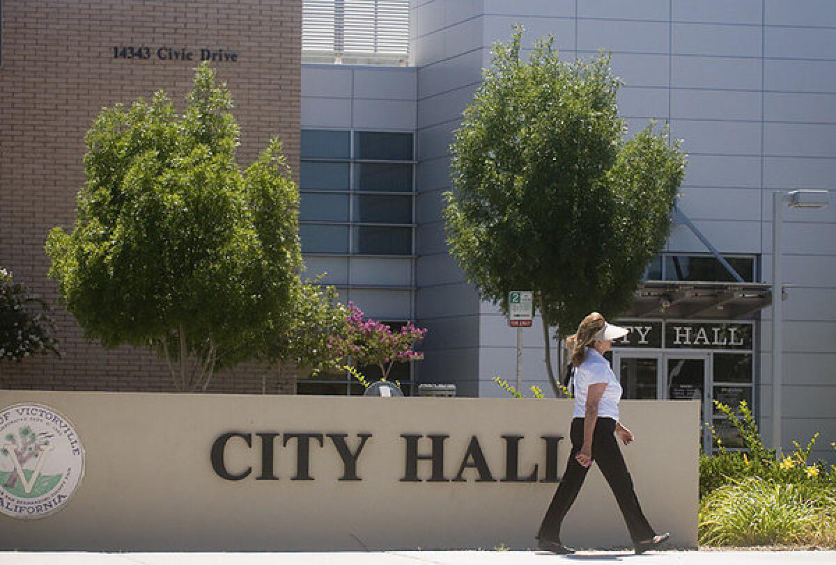As part of the recent budget deal, the state's public records laws will remain on the books but local governments won't be required to comply. Above: A woman walks in front of City Hall in Victorville, Calif.