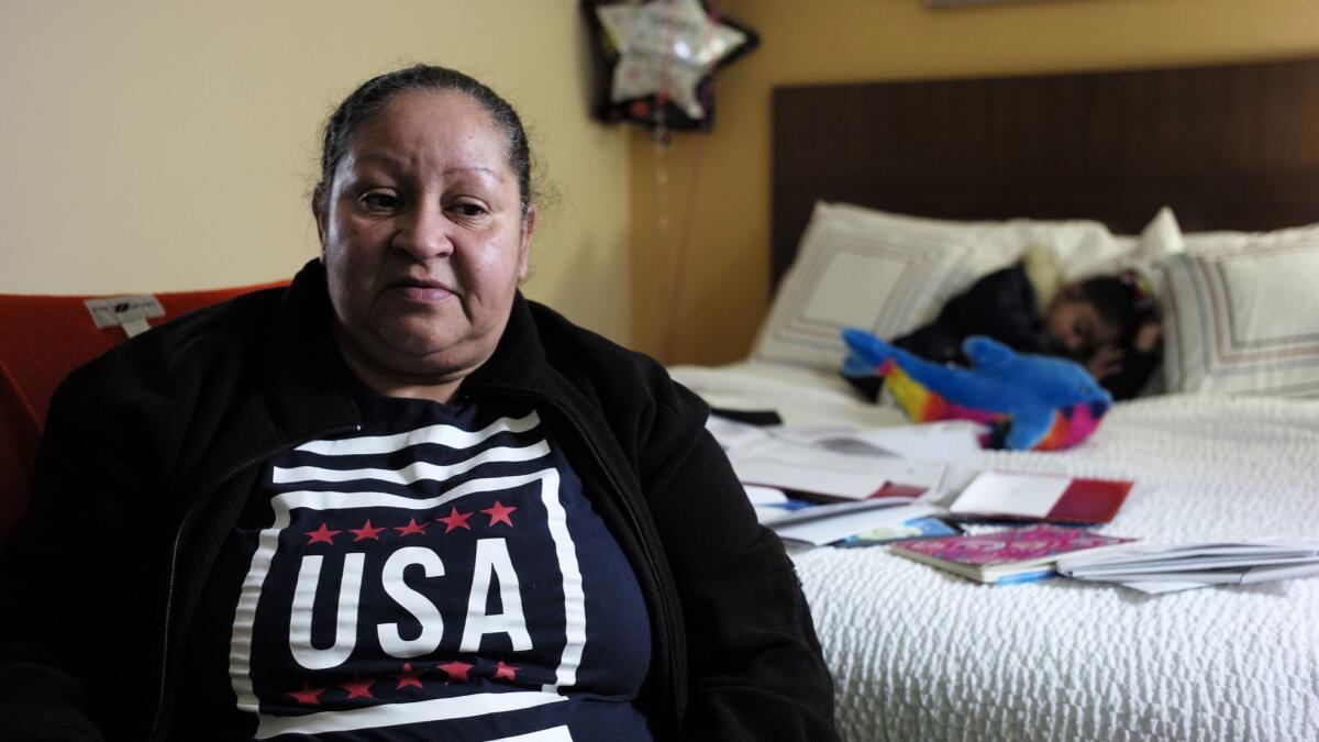 Maria Reyes, of San Juan, Puerto Rico, babysits six-year-old Junielis on Feb. 27 at a hotel in Dedham, Mass. Several Massachusetts groups helped Reyes when her FEMA hotel assistance ended after two months.