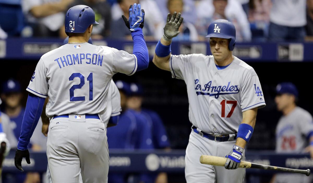 Dodgers' Trayce Thompson, left, high fives on-deck batter A.J. Ellis after his two-run home run during the second inning on Tuesday.