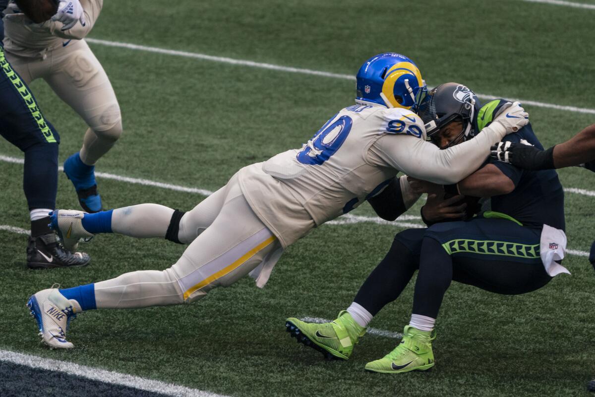 Los Angeles Rams defensive lineman Aaron Donald sacks Seattle Seahawks quarterback Russell Wilson.