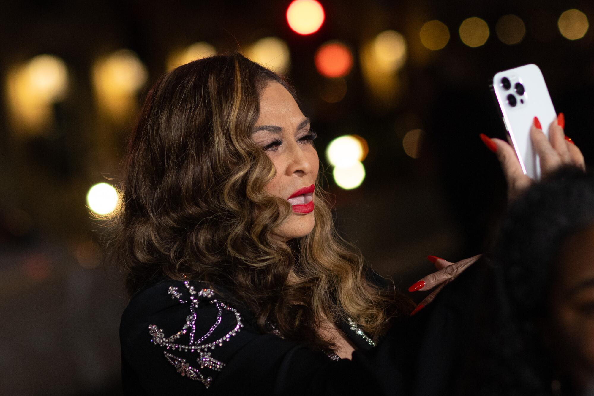 Tina Lawson, a.k.a. Tina Knowles, does a last check before walking the red carpet at the TCL Chinese Theatre in Hollywood