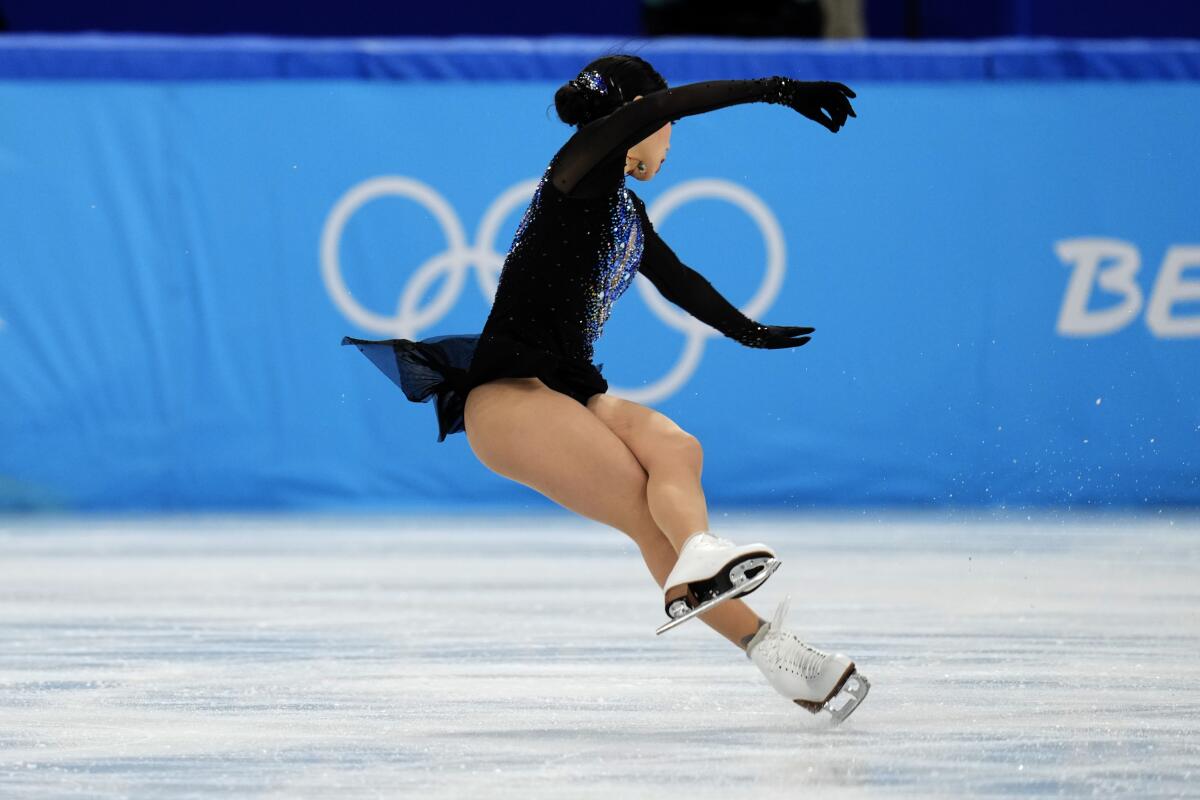Karen Chen, of the United States, falls in the women's short program team figure skating competition.