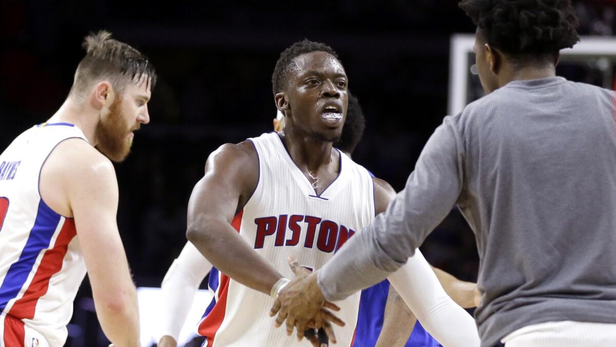 Pistons guard Reggie Jackson, center, is congratulated by teammates after making a three-point shot against the Wizards during the second half Friday.