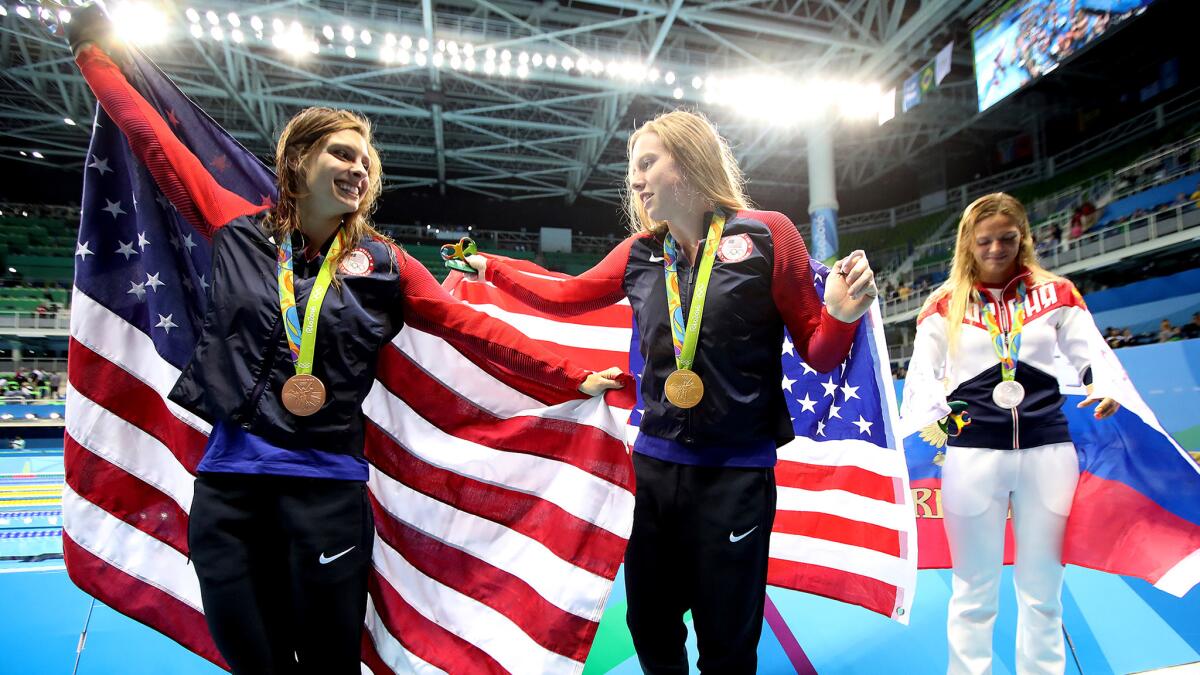 American swimmer Lilly King, center, not only won gold but helped serve up some patriotism with her harsh words for Russian rival Yulia Efimova, right, the silver medalist.