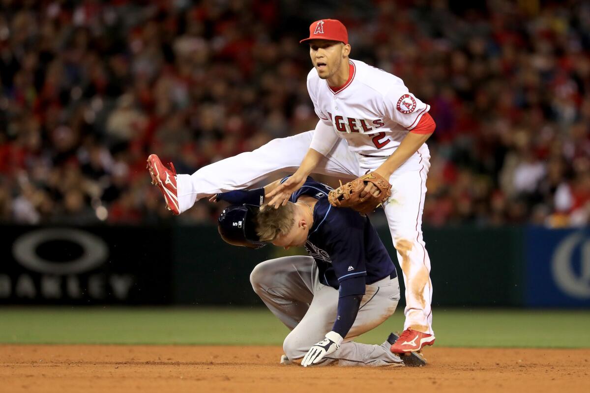 Angels shortstop Andrelton Simmons (2) leaps over sliding Rays outfielder Brandon Guyer after turning a double play during the fifth inning.
