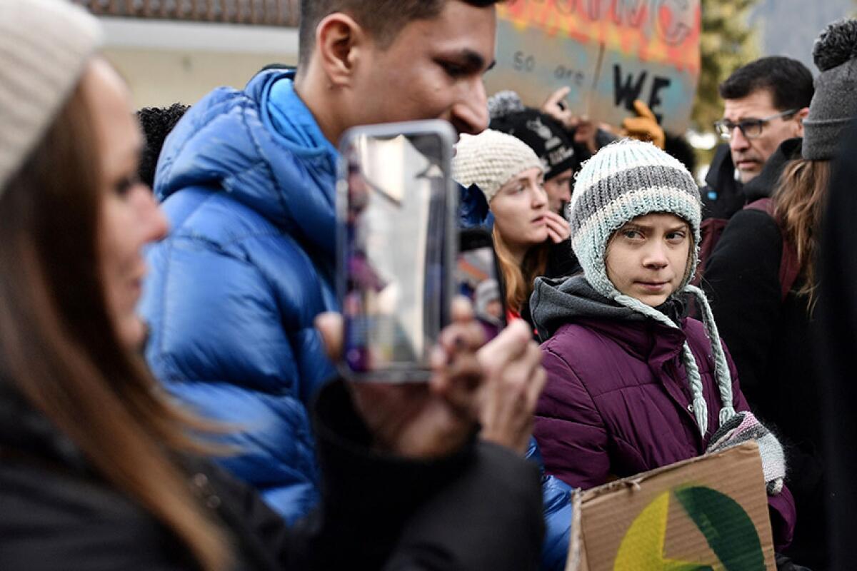 Swedish climate activist Greta Thunberg, right, marches during a "Fridays for Future" demonstration.