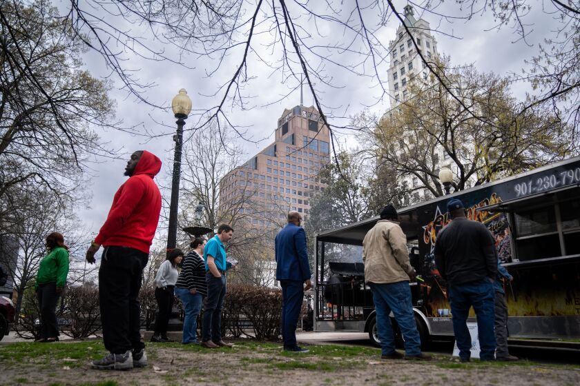 MEMPHIS, TN - MARCH 16: People wait in line at food trucks during lunchtime at Court Square Park in downtown Memphis on Thursday, March 16, 2023 in Memphis, TN. While Memphis isn't back to the same levels of in-person work like it was pre-pandemic, but it's returning faster than Los Angeles, San Francisco and other major cities across the United States. (Kent Nishimura / Los Angeles Times)
