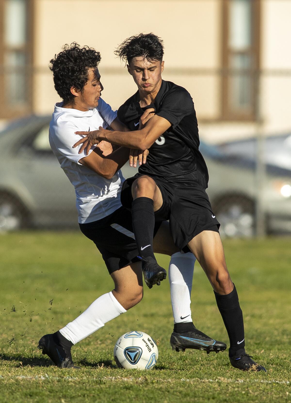 Los Amigos' Izaiah Franco and an Esperanza player collide while fighting for possession of the ball on Friday.