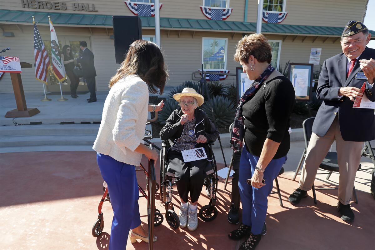 Jane Perlowin Weller (Army Air Corps), 100, center, is honored by state Assemblywoman Cottie Petrie-Norris, left, during a ceremony Friday at the Heroes Hall veterans museum in Costa Mesa.
