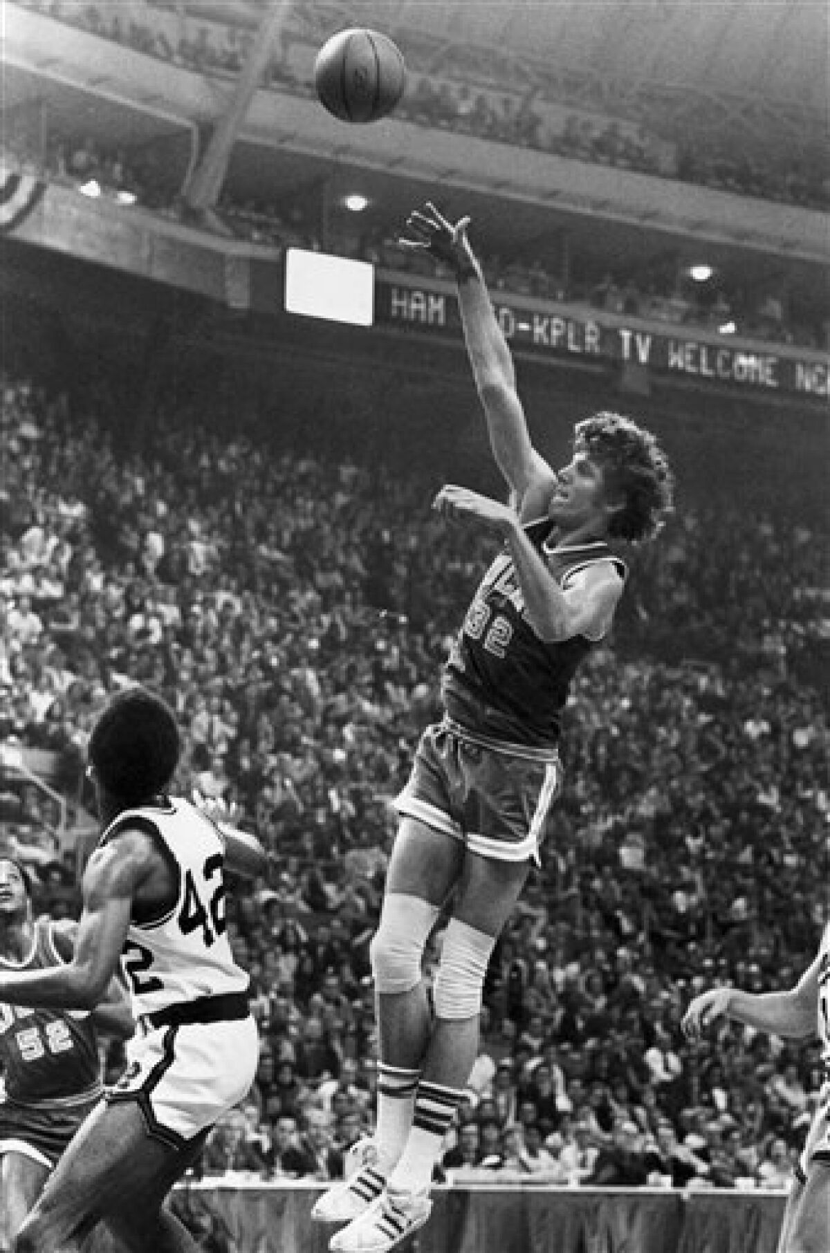 FILE - This March 26, 1973, file photo shows UCLA center Bill Walton shooting for two of his record 44 points against Memphis State in the final game of the NCAA basketball tournament in St. Louis, Mo. The 57-year-old Walton said that his former coach _ at the age of 99 _ was aware of UConn's streak. He thinks John Wooden would be proud of what UConn coach Auriemma has accomplished, as they have similiar coaching traits. (AP Photo, File)