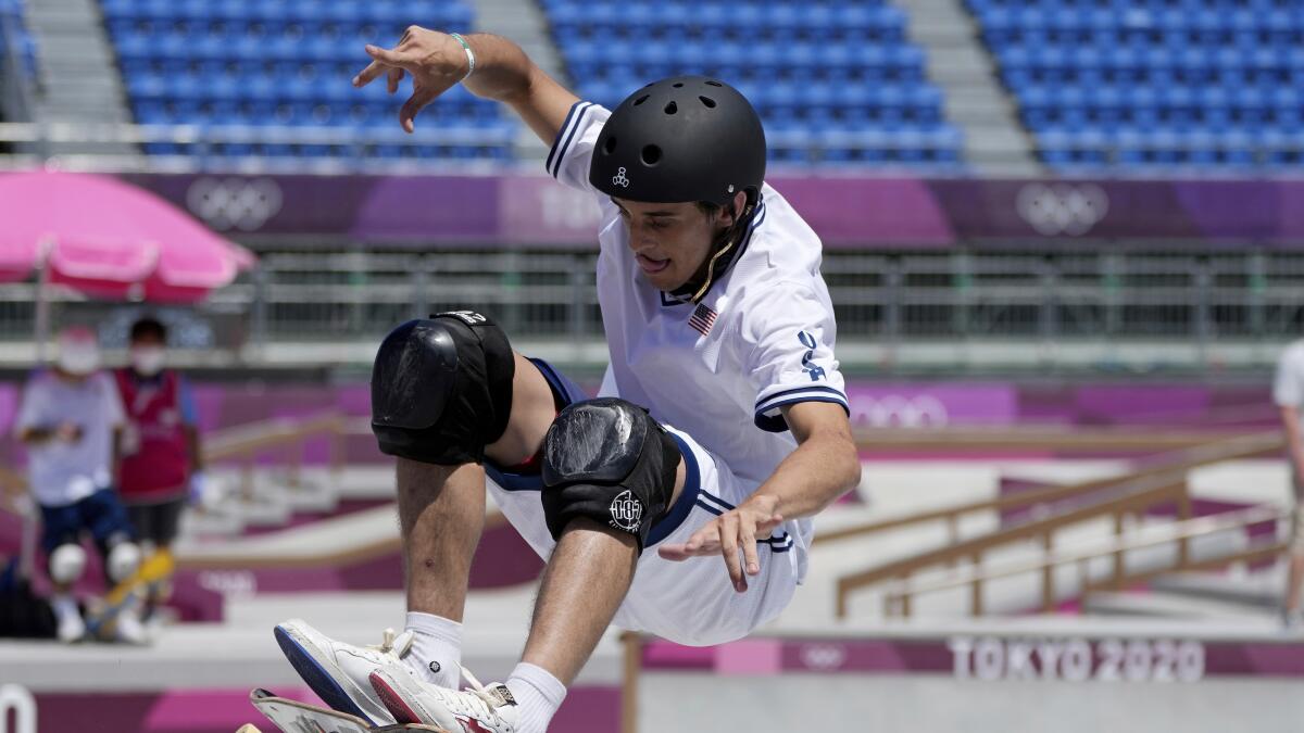 Cory Juneau, in helmet and kneepads, competes in men's skateboarding park at the Tokyo Olympics.