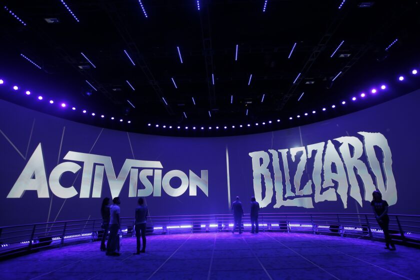 FILE - The Activision Blizzard Booth is shown on June 13, 2013, during the Electronic Entertainment Expo in Los Angeles. British antitrust regulators scrutinizing Microsoft's blockbuster purchase of videogame maker Activision Blizzard narrowed their investigation on Friday, March 24, 2023 by dropping concerns the deal would hurt the console gaming market. (AP Photo/Jae C. Hong, File)