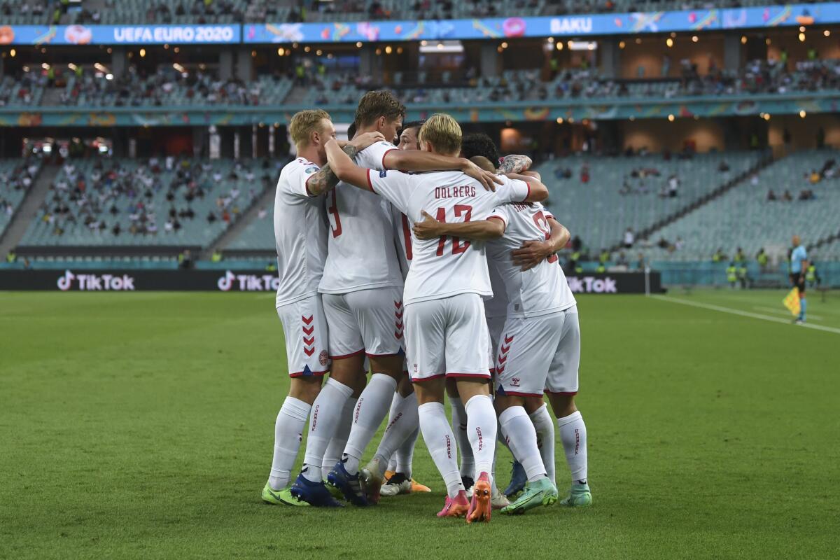Denmark's Thomas Delaney celebrates with teammates after scoring his side's opening goal during the Euro 2020 soccer championship quarterfinal match between Czech Republic and Denmark, at the Olympic stadium in Baku, Saturday, July 3, 2021. (Ozan Kose, Pool via AP)