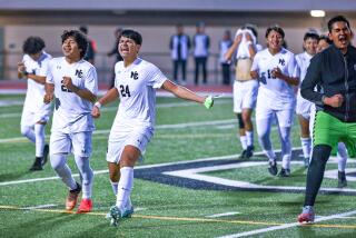 Eduardo Villegas (24) leads a celebration of Contreras soccer players after clinching first league title in school history.