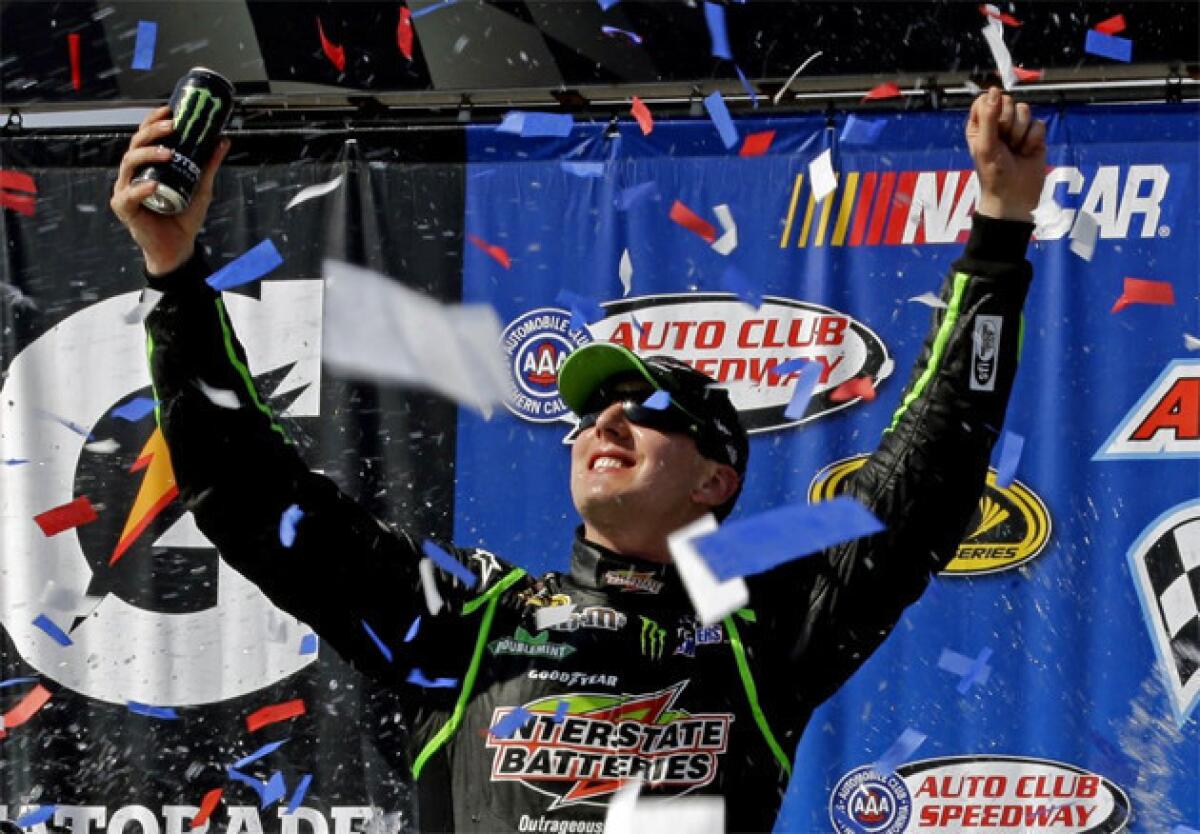 Kyle Busch celebrates his win at the Auto Club 400 race in Fontana.