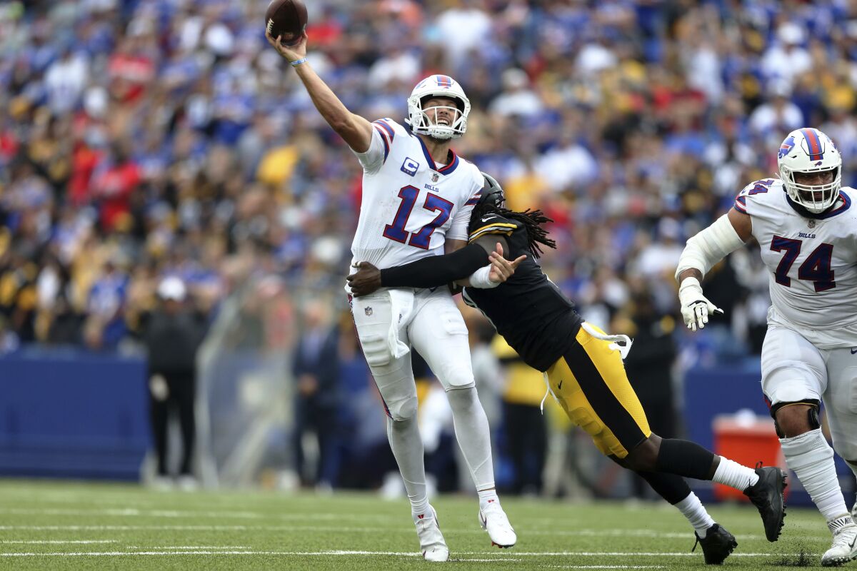Buffalo Bills quarterback Josh Allen (17) gets off a pass as he is hit by Pittsburgh Steelers linebacker Melvin Ingram during the second half of an NFL football game in Orchard Park, N.Y., Sunday, Sept. 12, 2021. (AP Photo/Joshua Bessex)